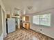 Bright kitchen with updated lighting, neutral cabinets, and decorative tile flooring at 13024 E Alaska Pl, Aurora, CO 80012