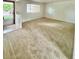 Bright and airy living room featuring neutral carpet, white walls, and plenty of natural light at 13024 E Alaska Pl, Aurora, CO 80012