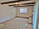 Comfortable living room with wood beam ceiling, a fireplace and lots of natural light at 13024 E Alaska Pl, Aurora, CO 80012