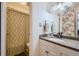 Well-lit bathroom with a decorative shower curtain, granite countertop, and modern fixtures at 5995 E Iliff Ave # 106, Denver, CO 80222