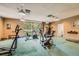 Well-equipped exercise room with various machines, a window, and ample space for a complete workout at 5995 E Iliff Ave # 106, Denver, CO 80222