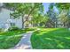 Well-manicured grounds and lawns with mature trees and sidewalks enhancing the community's appeal at 5995 E Iliff Ave # 106, Denver, CO 80222