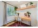 Bright, modern home office featuring a wooden desk, stylish chair, and natural light at 5995 E Iliff Ave # 106, Denver, CO 80222