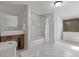 Bright bathroom features a modern vanity, large mirror, and combined tub and shower at 10707 Jordan Ct, Parker, CO 80134