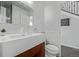 Stylish half bathroom featuring modern fixtures, a vessel sink, and a decorative mirror at 10707 Jordan Ct, Parker, CO 80134