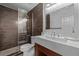 Modern bathroom featuring sleek vanity with a vessel sink and a glass-enclosed shower with tile surround at 10707 Jordan Ct, Parker, CO 80134