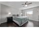 Bedroom featuring a large bed, ceiling fan, hardwood floors and a window for natural light at 10707 Jordan Ct, Parker, CO 80134