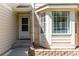 Inviting front entrance with a bay window, brick accents, and a well-maintained walkway at 10707 Jordan Ct, Parker, CO 80134