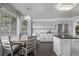 Kitchen with gray cabinetry, hardwood floors, stainless steel appliances, and a dining area at 10707 Jordan Ct, Parker, CO 80134