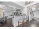 Kitchen with gray cabinetry, hardwood floors, and eat in bar area at 10707 Jordan Ct, Parker, CO 80134