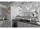 Modern kitchen showcasing an open layout, granite countertops, and views into the living space at 10707 Jordan Ct, Parker, CO 80134