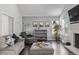 Cozy living room with brick fireplace, grey sofa, and open shelving at 10707 Jordan Ct, Parker, CO 80134