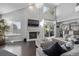 Living room with brick fireplace, dark hardwood floors, and backyard deck access at 10707 Jordan Ct, Parker, CO 80134