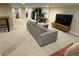 Finished basement featuring a comfortable couch, a TV, a safe, and neutral-colored walls at 2728 N Yates St, Denver, CO 80212