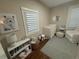 Bedroom featuring a crib, artwork, window with shades, and neutral-colored walls at 2728 N Yates St, Denver, CO 80212