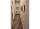 Hallway with warm wood flooring and natural-colored walls accented with framed artwork at 2728 N Yates St, Denver, CO 80212