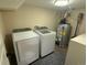 Cozy laundry room featuring modern Samsung washer and dryer and a water heater in a utility space at 2728 N Yates St, Denver, CO 80212