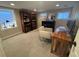 Basement office with hardwood bookshelves, desk, chair, and ample natural light from the windows at 2728 N Yates St, Denver, CO 80212