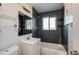 Updated bathroom with dark tile and a clean, modern aesthetic at 6825 E Martin Luther King Jr Blvd, Denver, CO 80207