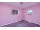 Charming bedroom with light pink walls and neutral carpeting at 6825 E Martin Luther King Jr Blvd, Denver, CO 80207