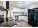 Modern kitchen with white cabinets, new appliances, and stylish backsplash at 6825 E Martin Luther King Jr Blvd, Denver, CO 80207