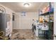 Basement laundry area with washer, dryer, and shelving at 6825 E Martin Luther King Jr Blvd, Denver, CO 80207