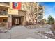 Building entrance with landscaping and walkway at 1162 Rockhurst Dr # 201, Highlands Ranch, CO 80129