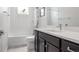 Clean bathroom features a combination tub and shower with updated vanity at 11027 Sunshimmer Cir, Parker, CO 80134