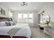 Bright bedroom with large windows, a cozy bed, and a vanity area at 11027 Sunshimmer Cir, Parker, CO 80134