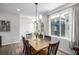 Bright dining room boasts modern lighting fixture, neutral paint, hard wood flooring and large window at 11027 Sunshimmer Cir, Parker, CO 80134