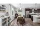 Open concept dining room shows elegant rug, picture window and hardwood style floors at 11027 Sunshimmer Cir, Parker, CO 80134