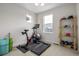 Exercise room featuring a stationary bike, treadmill, and free weights at 11027 Sunshimmer Cir, Parker, CO 80134