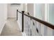 Carpeted upstairs hallway with dark wood and white banister railing at 11027 Sunshimmer Cir, Parker, CO 80134