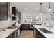 Well-equipped kitchen features stainless steel appliances, dark cabinetry, and stylish backsplash at 11027 Sunshimmer Cir, Parker, CO 80134