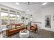 Bright living room with large windows, hardwood floors, and comfortable seating at 11027 Sunshimmer Cir, Parker, CO 80134