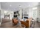 Open floor plan with hardwood floors, brick fireplace, contemporary lighting, and a comfortable living space at 11027 Sunshimmer Cir, Parker, CO 80134