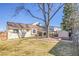 Spacious backyard featuring a well-maintained lawn, mature trees, and a charming patio area for outdoor enjoyment at 5927 S Kline St, Littleton, CO 80127