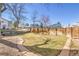 Well-maintained backyard featuring green grass, wooden fence and mature trees at 5927 S Kline St, Littleton, CO 80127