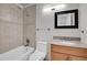 Bathroom featuring a tub, shower, tile surround, granite top vanity and decorative mirror at 5927 S Kline St, Littleton, CO 80127