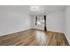 Bedroom featuring hardwood floors, white walls, modern lighting and window with dark curtains at 5927 S Kline St, Littleton, CO 80127