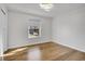 Bright bedroom with natural light from a window, complemented by wood floors at 5927 S Kline St, Littleton, CO 80127