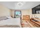 Comfortable bedroom featuring natural light, wood floors, and a decorative dresser at 5927 S Kline St, Littleton, CO 80127