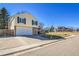 Charming two-story home with a two-car garage, brick accents, well-maintained lawn, and mature trees at 5927 S Kline St, Littleton, CO 80127