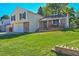 Home showcasing a well-maintained lawn, a two-car garage, and a inviting front porch at 5927 S Kline St, Littleton, CO 80127