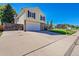Two-story home featuring a two-car garage, well-maintained lawn, and a concrete driveway at 5927 S Kline St, Littleton, CO 80127