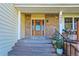 Inviting brick home featuring a stylish wooden front door with decorative glass and well-maintained landscaping at 5927 S Kline St, Littleton, CO 80127