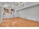Spacious living room featuring vaulted ceilings, hardwood floors, and open floor plan to the staircase and kitchen at 5927 S Kline St, Littleton, CO 80127