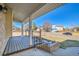 Covered front porch features wood decking, brick accents, and provides a welcoming entrance at 5927 S Kline St, Littleton, CO 80127