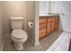 Well-lit bathroom with a toilet and wood vanity with granite counter at 935 N Pennsylvania St # 3, Denver, CO 80203