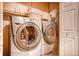 Convenient laundry area featuring a stacked washer and dryer with extra storage and room for organizing at 935 N Pennsylvania St # 3, Denver, CO 80203